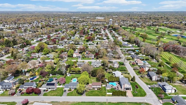 drone / aerial view with view of golf course and a residential view