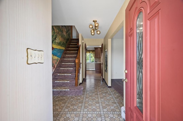 entrance foyer featuring baseboards and stairway