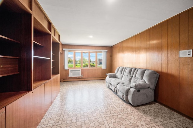 living area featuring baseboard heating, wood walls, and a wall unit AC