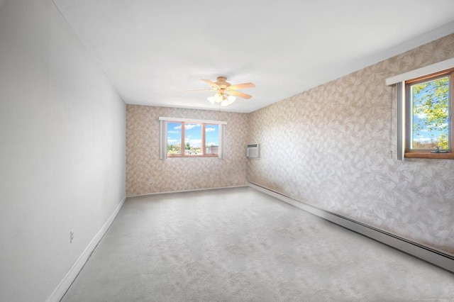 empty room with plenty of natural light, baseboards, ceiling fan, and wallpapered walls