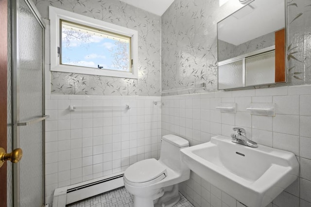 full bath with toilet, a wainscoted wall, a baseboard heating unit, a shower stall, and a sink