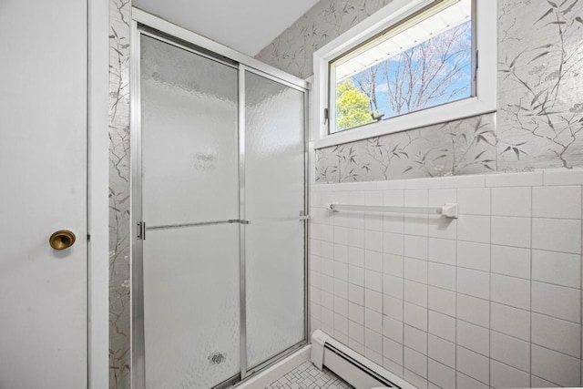 bathroom with a wainscoted wall, wallpapered walls, tile walls, a baseboard radiator, and a stall shower