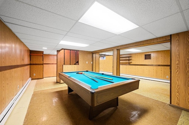 rec room featuring tile patterned floors, wood walls, and baseboard heating