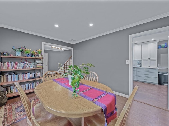 9 Cresthill Pl, Smithtown, NY 11787 - dining room with light wood finished floors, ornamental molding, recessed lighting, baseboards, and a chandelier