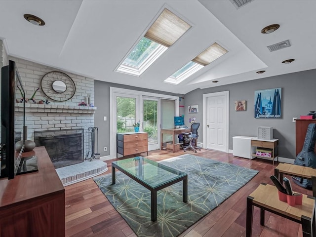 9 Cresthill Pl, Smithtown, NY 11787 - living room featuring a skylight, an office area, wood finished floors, vaulted ceiling, and a brick fireplace