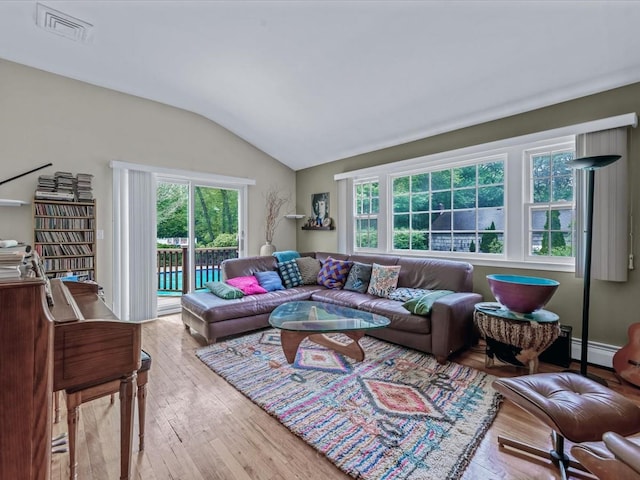 9 Cresthill Pl, Smithtown, NY 11787 - living area with vaulted ceiling, hardwood / wood-style floors, plenty of natural light, and baseboard heating