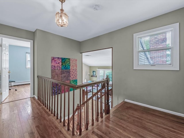 9 Cresthill Pl, Smithtown, NY 11787 - hallway with an upstairs landing, a baseboard radiator, hardwood / wood-style flooring, and baseboards