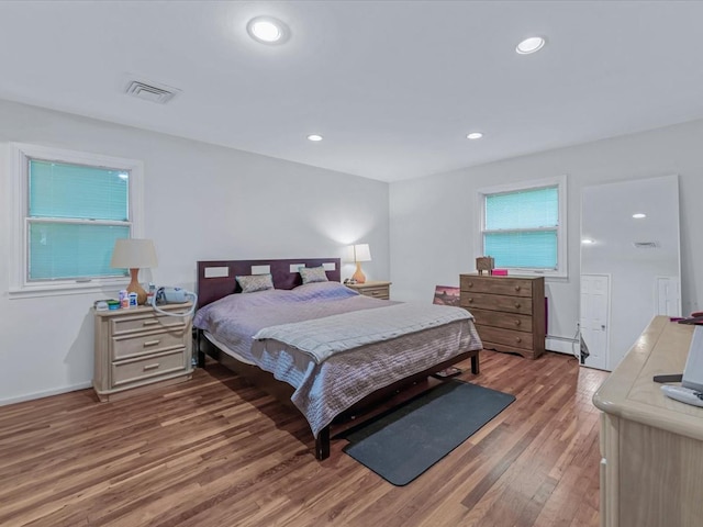 9 Cresthill Pl, Smithtown, NY 11787 - bedroom with light wood finished floors, baseboard heating, recessed lighting, and baseboards