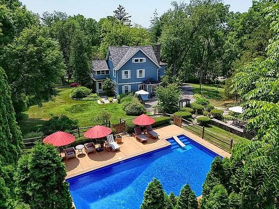 pool featuring fence and a patio