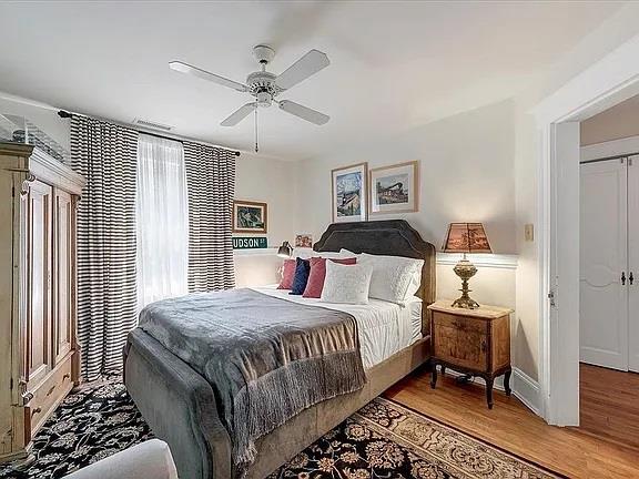 bedroom with baseboards, light wood finished floors, and ceiling fan