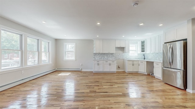 13108 160th St, Jamaica, NY 11434 - kitchen with freestanding refrigerator, plenty of natural light, decorative backsplash, white cabinets, and recessed lighting