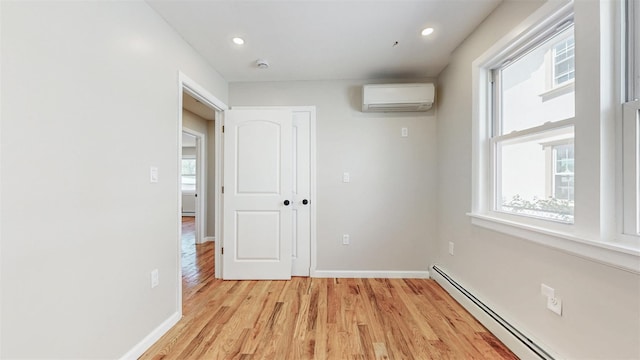 13108 160th St, Jamaica, NY 11434 - unfurnished room featuring a baseboard heating unit, an AC wall unit, light wood finished floors, baseboards, and recessed lighting