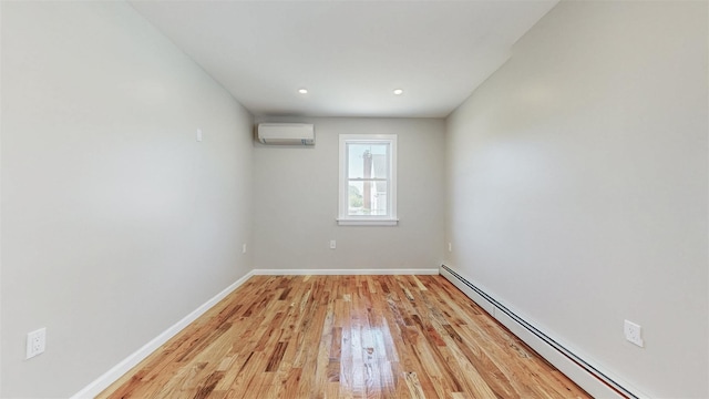 13108 160th St, Jamaica, NY 11434 - unfurnished room with a baseboard heating unit, a wall mounted air conditioner, light wood finished floors, baseboards, and recessed lighting