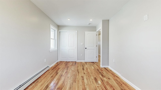 13108 160th St, Jamaica, NY 11434 - unfurnished bedroom with a baseboard radiator, light wood-style floors, baseboards, recessed lighting, and a closet