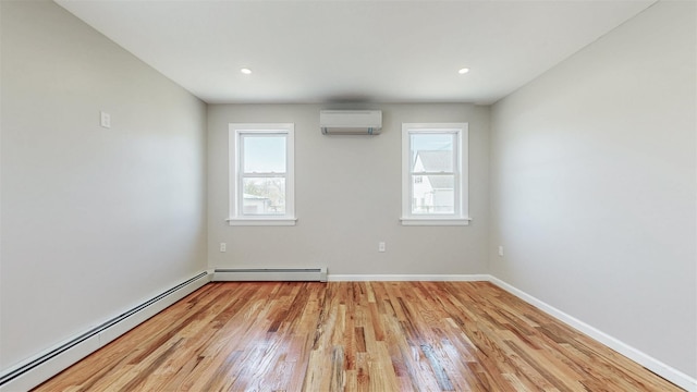 13108 160th St, Jamaica, NY 11434 - unfurnished room featuring an AC wall unit, a baseboard radiator, light wood-type flooring, baseboards, and recessed lighting