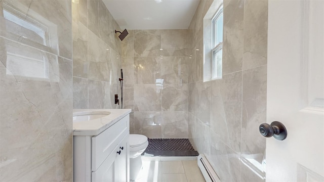 13108 160th St, Jamaica, NY 11434 - bathroom featuring baseboard heating, tile walls, tiled shower, vanity, and toilet