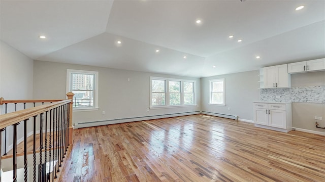 13108 160th St, Jamaica, NY 11434 - unfurnished living room with light wood-type flooring, recessed lighting, lofted ceiling, a baseboard radiator, and baseboards