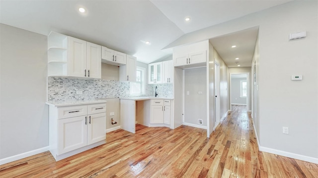 13108 160th St, Jamaica, NY 11434 - kitchen featuring open shelves, white cabinets, decorative backsplash, light wood finished floors, and lofted ceiling