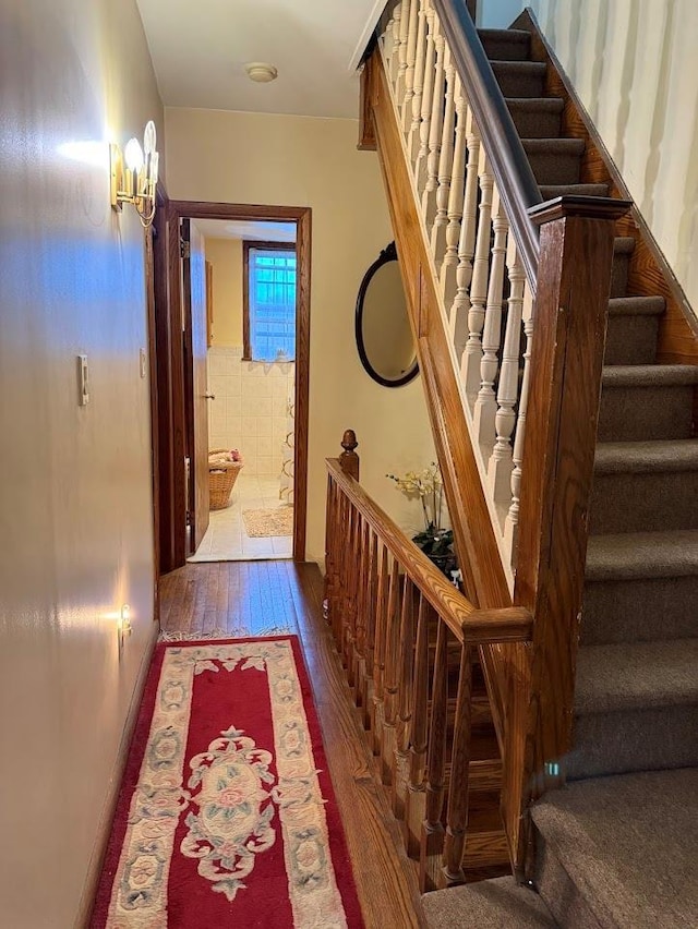 hallway featuring stairway and hardwood / wood-style flooring