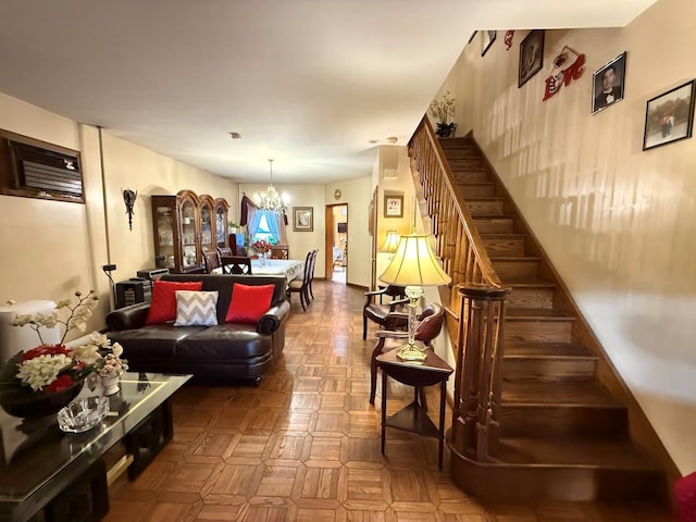 living room featuring stairs and a chandelier