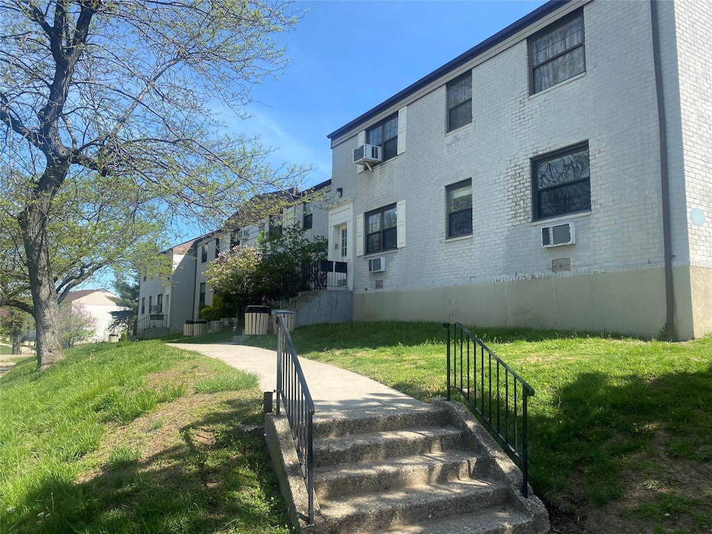 view of building exterior with cooling unit and an AC wall unit