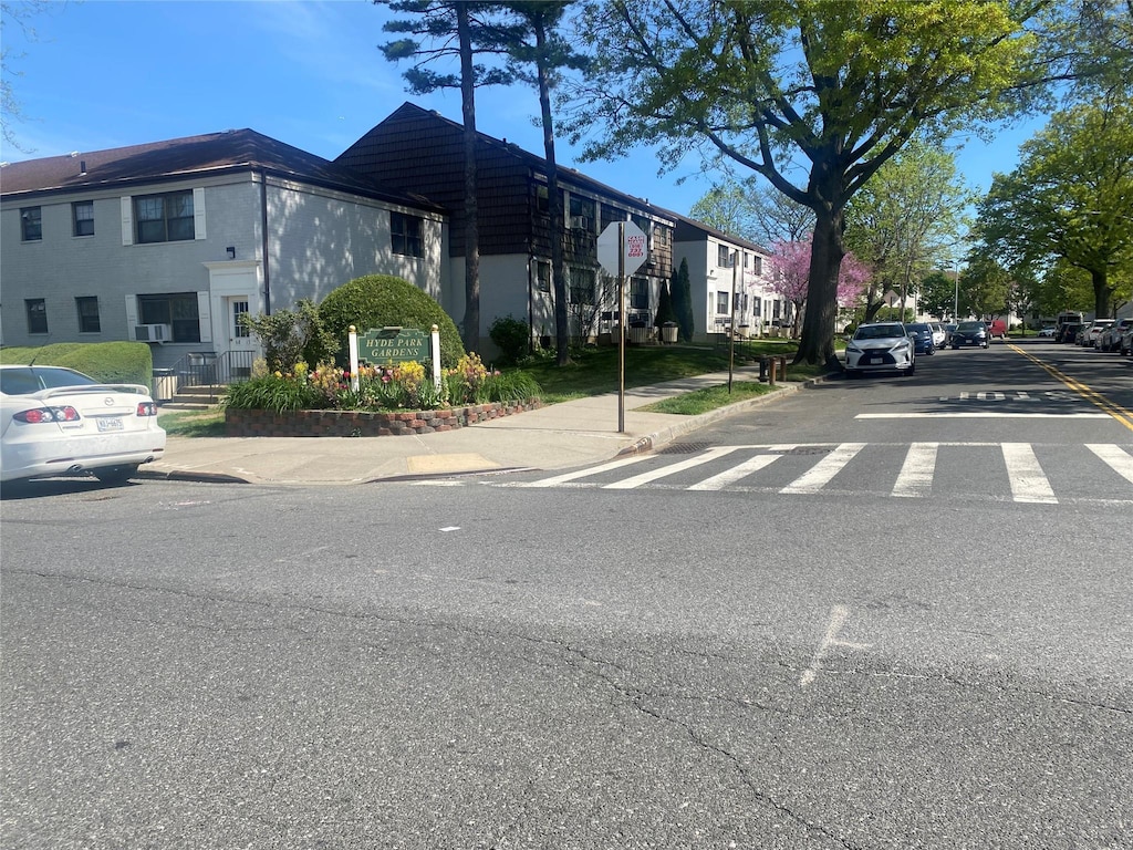 view of street featuring traffic signs, sidewalks, and curbs
