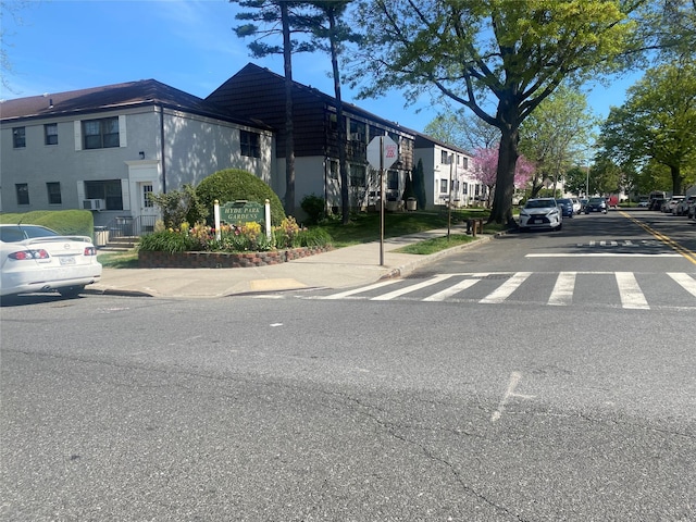 view of street featuring traffic signs, sidewalks, and curbs