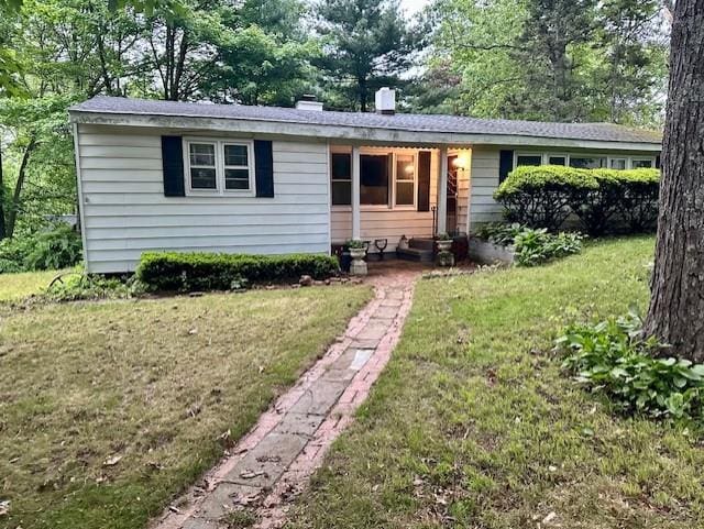 1 Rutland Dr, Patterson, NY 12563 - ranch-style home with a front yard, view of scattered trees, and a chimney