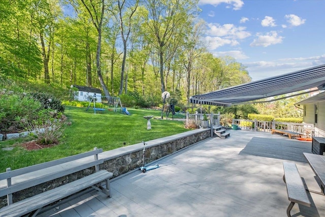 exterior space featuring a wooden deck and playground community