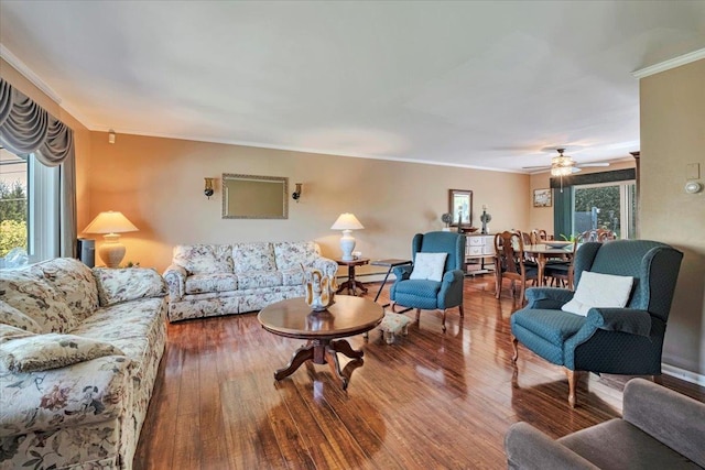 living room featuring ornamental molding, a ceiling fan, and wood finished floors
