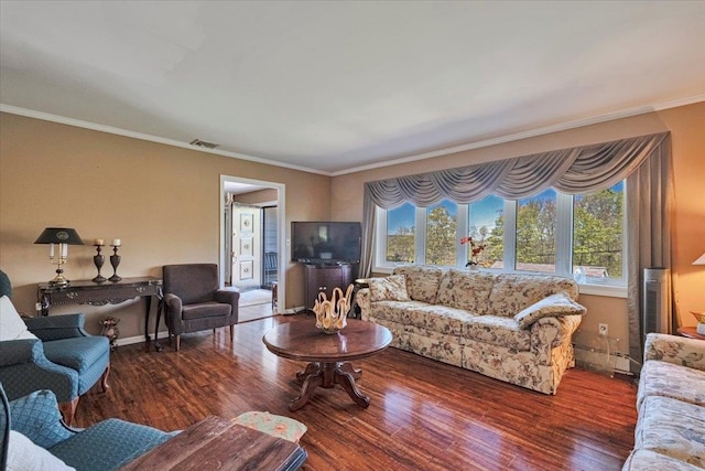 living room with crown molding, baseboards, wood finished floors, and visible vents