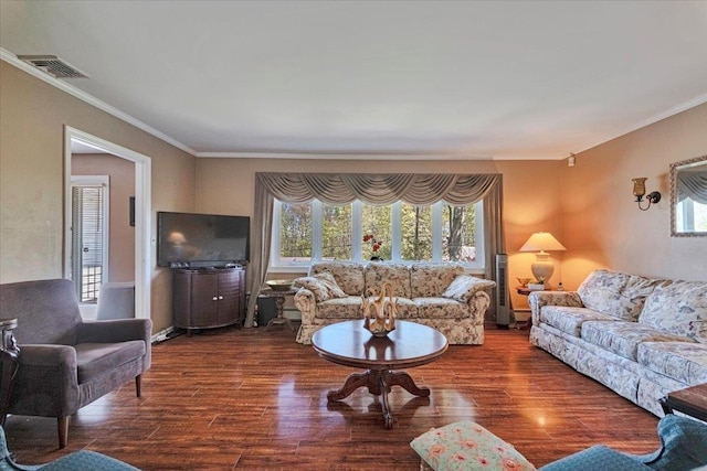 living area with visible vents, ornamental molding, wood finished floors, and a wealth of natural light