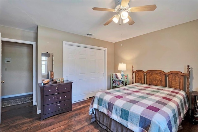 bedroom featuring a closet, ceiling fan, visible vents, and dark wood-type flooring