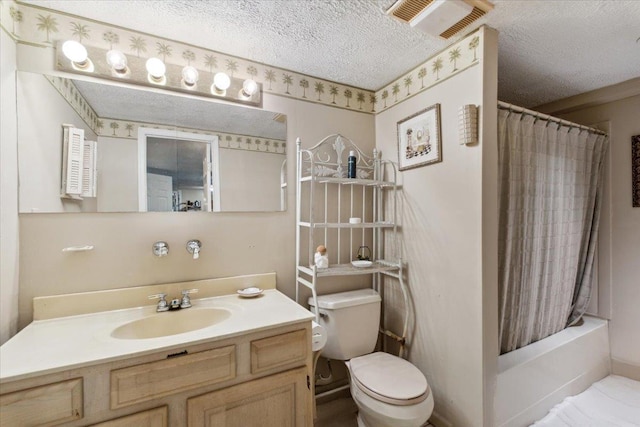 full bath featuring vanity, toilet, a textured ceiling, and visible vents