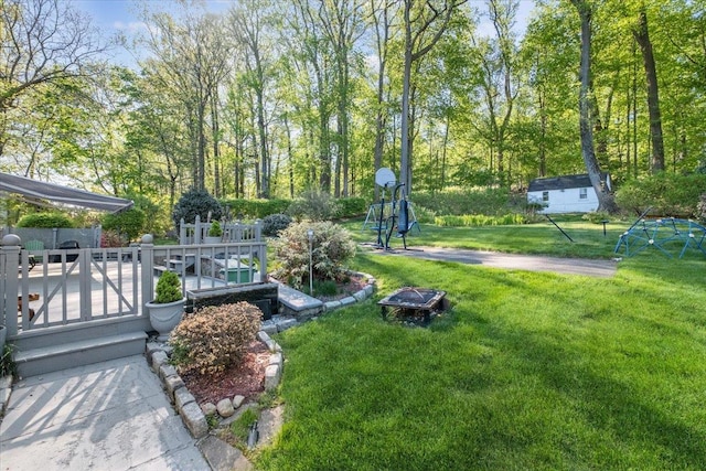 view of home's community featuring a yard and an outdoor fire pit