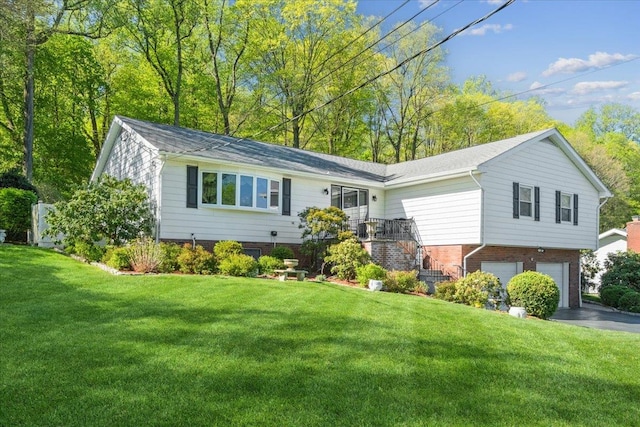 ranch-style home with a garage, a front lawn, and driveway