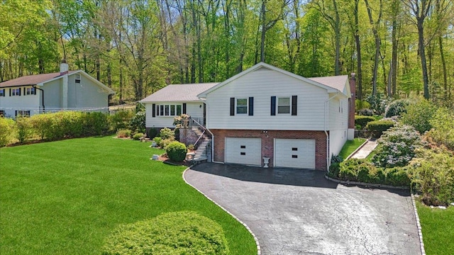 view of front of property with a front lawn, brick siding, a garage, stairway, and driveway
