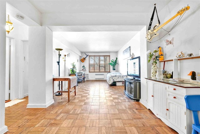 living room featuring baseboards and radiator heating unit