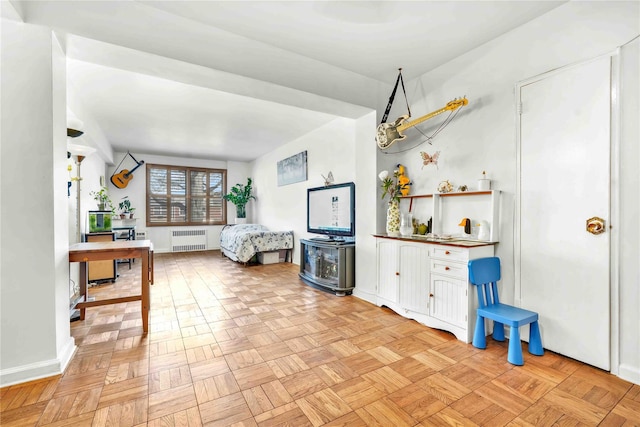 living room featuring baseboards and radiator
