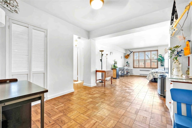 interior space with radiator and baseboards