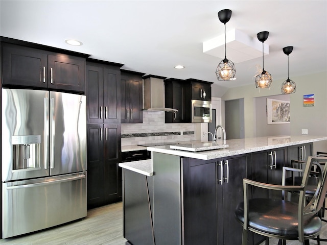 256 Macy Rd, Briarcliff Manor, NY 10510 - kitchen featuring light wood finished floors, wall chimney exhaust hood, stainless steel appliances, decorative backsplash, and a kitchen bar