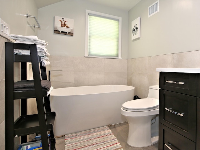 256 Macy Rd, Briarcliff Manor, NY 10510 - bathroom with visible vents, a freestanding tub, tile walls, tile patterned flooring, and toilet