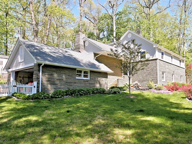 256 Macy Rd, Briarcliff Manor, NY 10510 - view of home's exterior with fence, stone siding, a chimney, a shingled roof, and a lawn