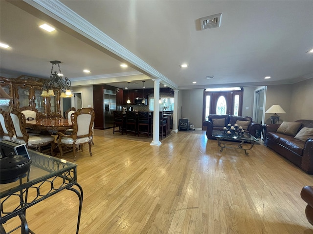 79 Constellation Rd, Levittown, NY 11756 - living room featuring ornamental molding, light wood finished floors, decorative columns, a chandelier, and recessed lighting