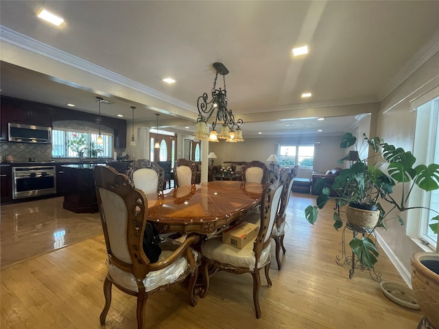 79 Constellation Rd, Levittown, NY 11756 - dining area with ornamental molding, light wood-style flooring, and recessed lighting
