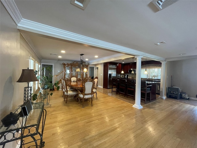 79 Constellation Rd, Levittown, NY 11756 - dining area with decorative columns, ornamental molding, light wood-style floors, recessed lighting, and a chandelier