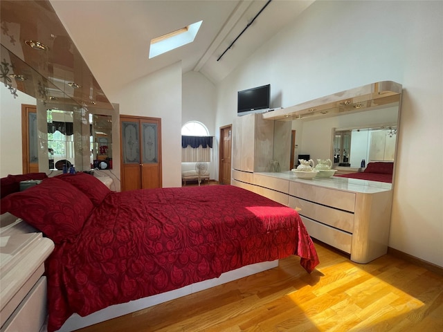 79 Constellation Rd, Levittown, NY 11756 - bedroom featuring a skylight, high vaulted ceiling, and light wood finished floors