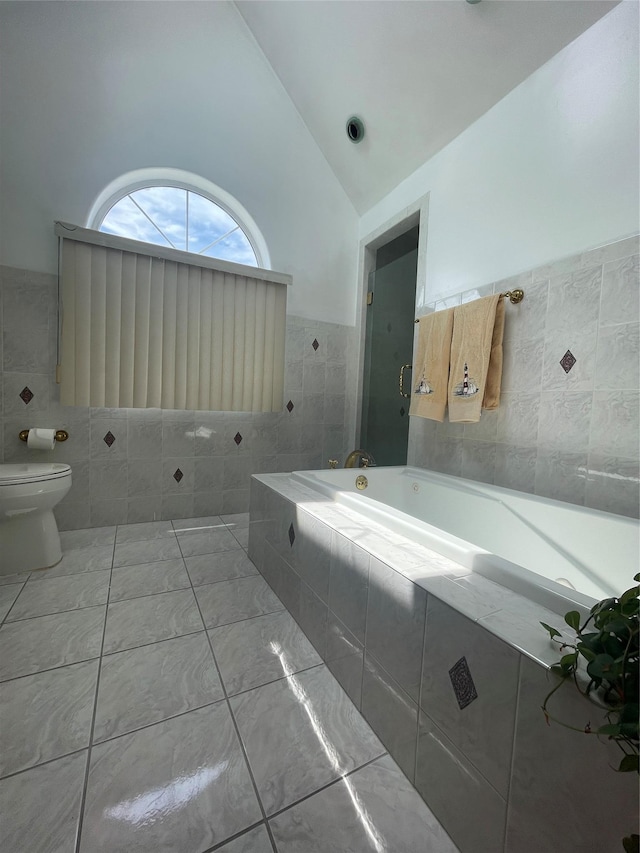 79 Constellation Rd, Levittown, NY 11756 - bathroom featuring tile walls, lofted ceiling, and a bath