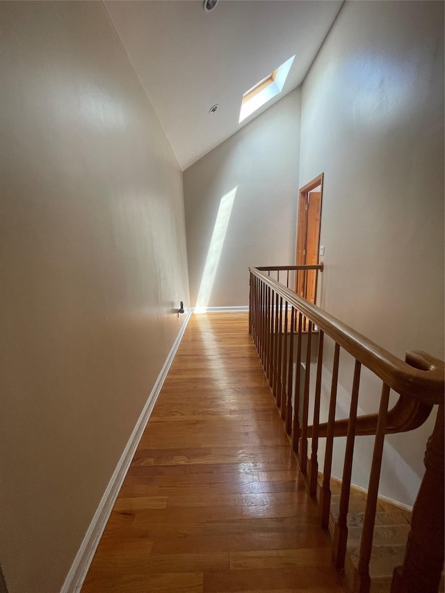 79 Constellation Rd, Levittown, NY 11756 - staircase featuring a skylight, wood-type flooring, and high vaulted ceiling