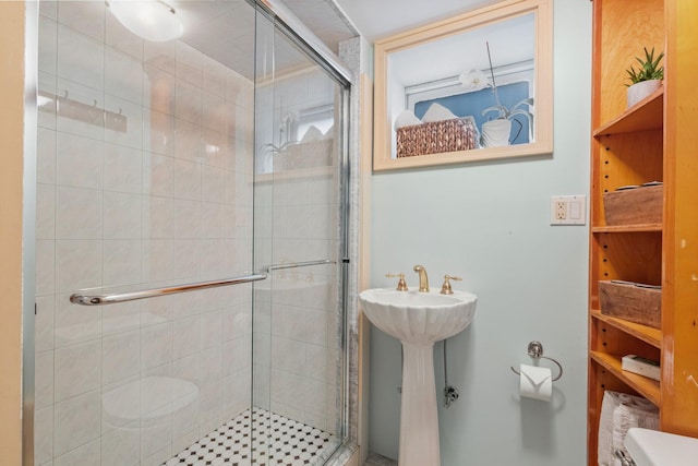 full bath with a shower stall and a sink